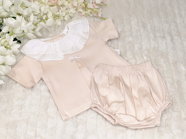 Pastel peach shorts and frilled top