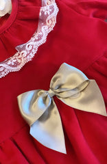 Traditional red dress with cream lace and gold bows
